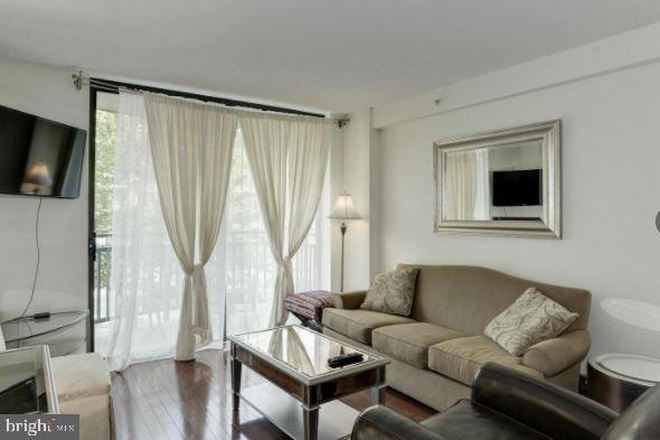 Imagine warm breezes and lounging in the living room. - Elevated Living Near the National Cathedral Condo