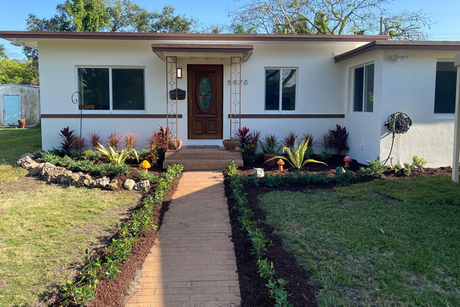 Front of the House - Prime location! Remodeled 4BD/2BA, open kitchen, impact windows, pool, spacious yard.