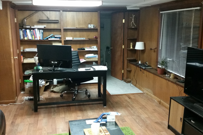 work area with a desk, chair, and wall-mounted shelves - Private, Fully Furnished Apartment Steps from UMass – Utilities Included