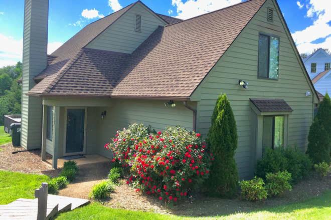 Front of home, featuring well-maintained landscaping and rose bushes. - 4 Bed/2.5 Bath with huge deck and backyard in quiet Crozet