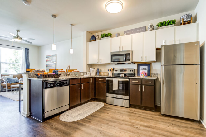 Open kitchen connected to living room - Rush Student Living Apartments