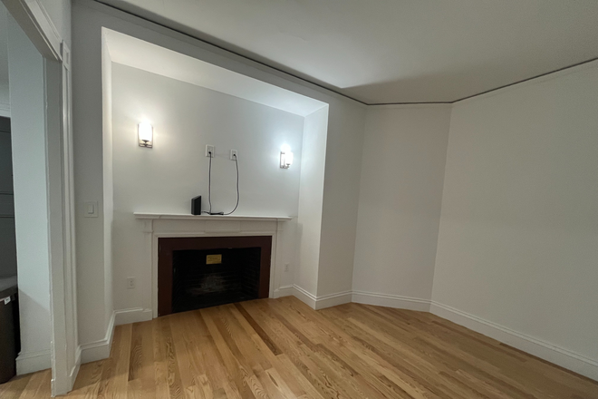 Living Room - Charming Unit in Historic Building with Modern Touches and Cozy Fireplace - All Utilities Included! Apartments