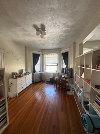 Main room (note mounted TV facing the windows) - Partially Furnished Studio
