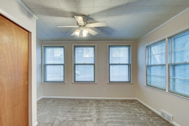 bedroom with many windows and new carpet - 3BR Apartment in Triplex - Historic Park near Universities, Downtown/Midtown/Blackstone