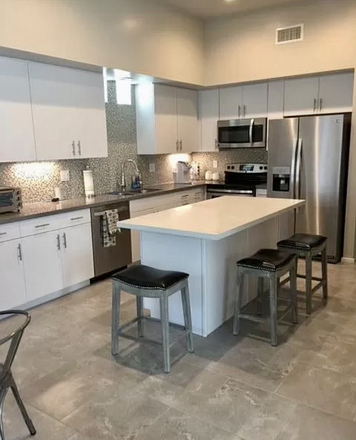 Beautiful, fully stocked kitchen - Upstairs Bedroom w/ensuite bathroom in fully-furnished 3/3 home, with garage parking