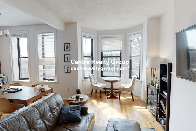 Living Room - Charming and Spacious 3-bed, 1.5 bath w/ exposed brick! Avail. 9/1/25! Apartments