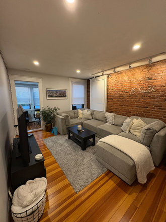 Beautiful livingroom with exposed brick, hardwood floors and plenty of light. - Sweet 1 + bed in prime location!! Available August 20th!!