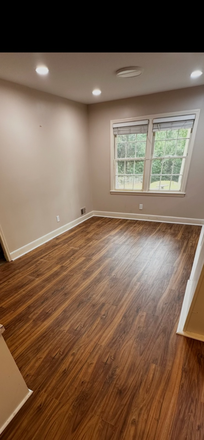 BEDROOM WITH HARDWOOD FLOORS - The HALL ESTATES House