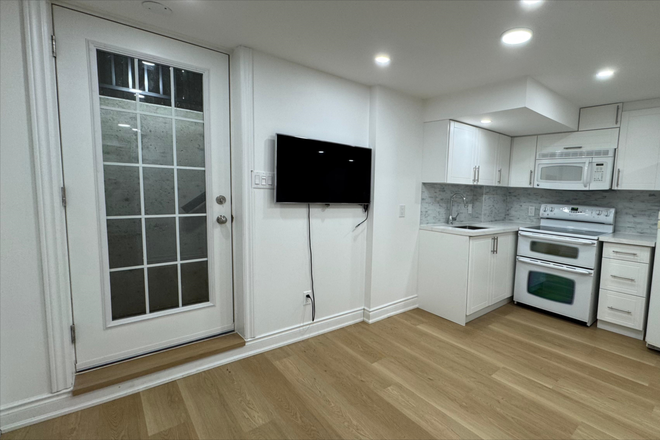 Living Room (TV Included) - One bedroom + Den (Can fit bed) Separate Entrance Basement Apartment ; direct bus availabl