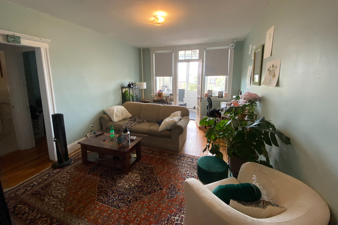 Living room and enclosed porch - NO FEE 1 bedroom apartment with enclosed porch, HT/HW incl, laundry in building!