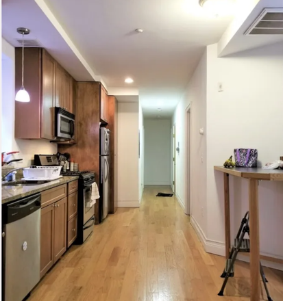Visit hubrealtyproperties.com - Beautiful 4 bedroom floor through with laundry in unit, dishwasher and deck, next to green line T Apartments