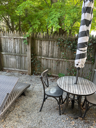 Patio off bedroom with loungers, umbrella, table and chairs. - Princeton Hideaway (listed on Airbnb also) Apartments