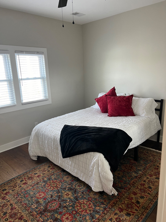 Front bedroom queen bed and linens included with a rug - Woodall Cozy Court Duplex  3 bedroom available duplex Walking Distance to Campus Duplex