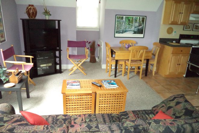 Living Room with 65" TV - Lakefront Apt. Fully furnished. Tranquil woodland setting. Loaded with amenities.