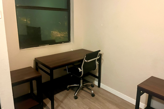 Desk Area looking out a large window - I don't have a photo of the bed area, it is directly behind this desk area. - The Suites at NAU Apartments