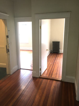 Visit hubrealtyproperties.com - Handy front facing one bedroom split with decorative fireplace, in Allston Apartments