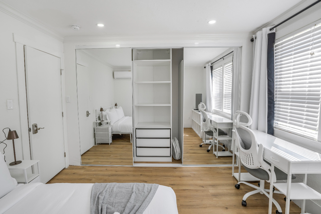 Bedroom has double sliding mirror closet door with organizer - Recently Remodeled Fully Furnished Laundry All Utilities Included Townhome