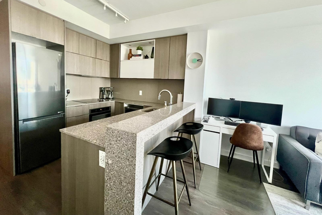 -Kitchen, dining bar, & secondary workspace - Furnished 1BR/1BA+Den with Laundry 685 sq ft 12th-Floor Modern Condo in Regent Park