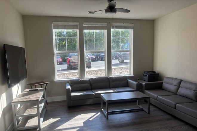 Living room: TV included - The Oasis Vue Student Housing first floor 3 bedroom with personal office rooms Apartments