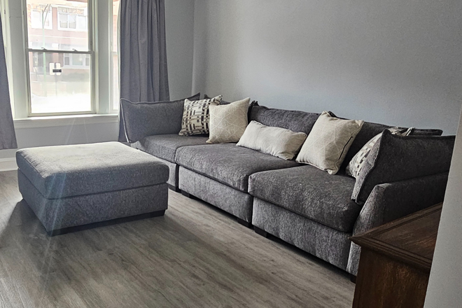 Family room view from dining room - Fully Furnished 2BR Near UIC | Utilities Included | Garage Parking | Available Now