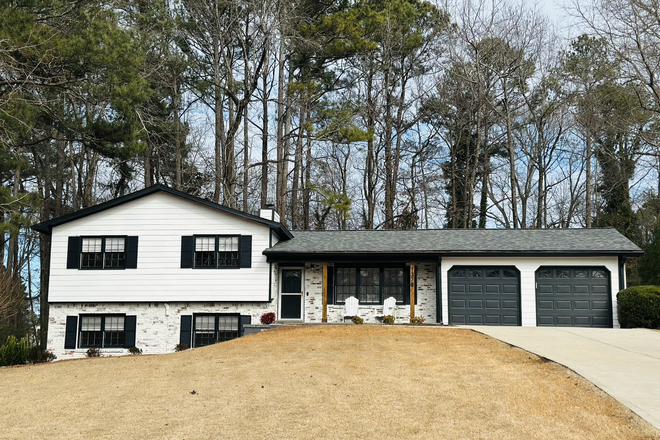 Building Front - Private, Fully Furnished Suite - Private kitchen, washer, wifi + more! Apartments