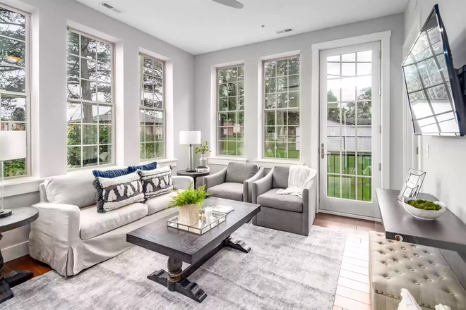 Open living room with tall windows letting - Keenan Court Flats
