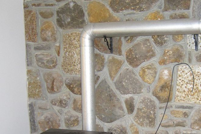 Large living room and pellet stove. - Finished Basement with private entrance, kitchen, bathroom, and 1 bedroom. House