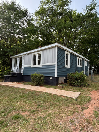 Front of house - Blue and gray house with fenced yard/ 1 mile from College of Veterinary Medicine