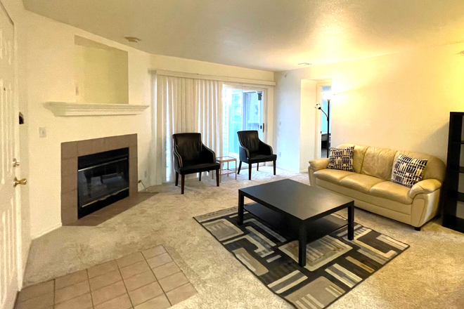 Living Room with fireplace and balcony - 2 Bed/2 Bath Furnished Apartment Next to Main Campus and Short Walk to East Campus