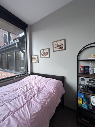 Bed and window - The Core Apartment 718