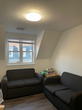 Furnished Living Room Area with Window - South Campus Commons Bldg 6 Apartments