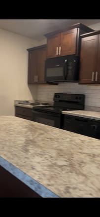 All photos are screenshots from a recorded video walkthrough of the apartment. This is a partial shot of the kitchen - BerryTree Apartments
