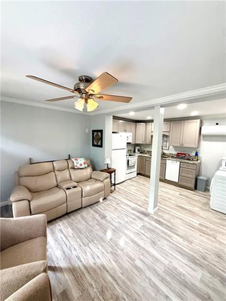 Living room with new vinyl plank flooring - Charming/Remodeled Uptown Condo Located right off St Charles. Ave. and walking distance to Audubon P