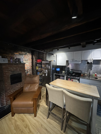 Living area - Gorgeous 2 bed in Beacon Hill w/ exposed brick & decorative fireplace! Apartments