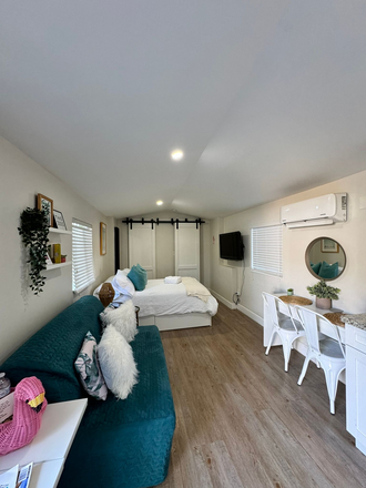 Queen size futon, desk/dining table, closet, and bathroom door. - Guesthouse studio with parking and laundry centrally located