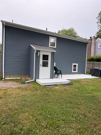 Back of house with deck. - 2 bedroom and 2 bathroom home. ALL UTILITIES INCLUDED IN RENT!