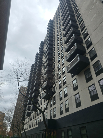 View of building from below - Highrise Chinatown Apartment next to F train, 15th Floor with balcony and view over river