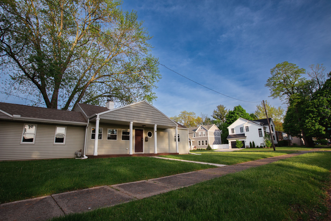 Exterior with large yard, front porch and back paver patio w 1-car garage and driveway - 7-Min Walk to ND: A Clean, Cozy, Quiet 3-BR Home (Skip the Campus Parking)
