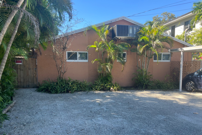 Front of duplex apartment with parking area - Desirable Coconut Grove apt. Close to Campus.
