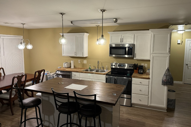 Kitchen with island - Room available in nice 3 BR fully furnished house close to campus with 2 existing male tenants