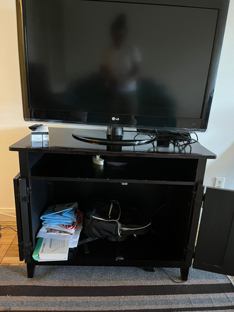 TV and stand - Large 1 Bedroom apartment ($1300/mo)