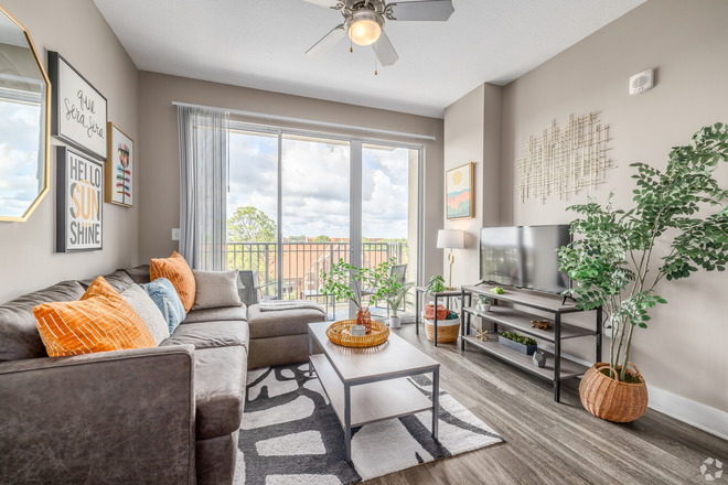Living room with campus view - The Standard at Gainesville Apartments