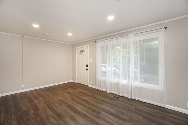 Living Room with Large Window for Natural Light - Totally Renovated Home in Clifton Gas Light District on Cul-de sac