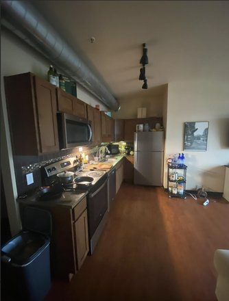 Kitchen. Four burner stove-top, oven, microwave. - Lofts on College