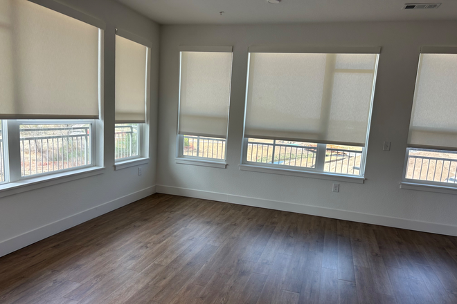 Living room off of kitchen (patio in back of picture) - The Hayes Apartments