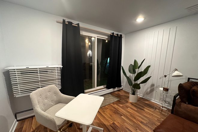 Sliding door to patio, rolling chair and height adjustable small desk - West Village 3 Condo