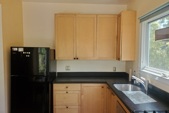 Kitchen from front bay window - 1 BR partial-furnished unit with great kitchen within victorian building, containing three units
