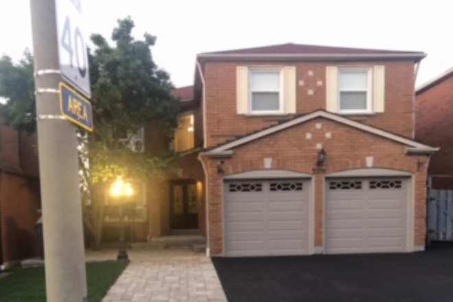 Frint of house. Apartment entrance to through the blue gate on right. - 1 bedroom basement apartment with den, kitchen and washroom, separate entrance