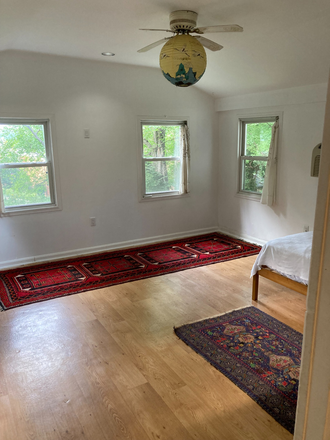 Living room.  4 windows total. Front windows look onto back garden - 1 Bed 1 Bath Apartment