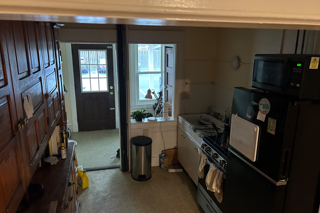 This is the kitchen. You see cupboards to your left, stove and oven to your right, and backdoor towards the front - 20 Hungerford Terrace Apartments